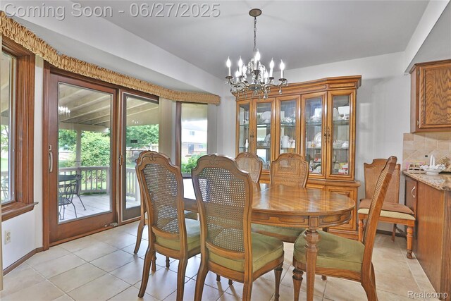 42471 Arcadia Dr, Sterling Heights, MI 48313 - dining room featuring a chandelier and light tile patterned floors