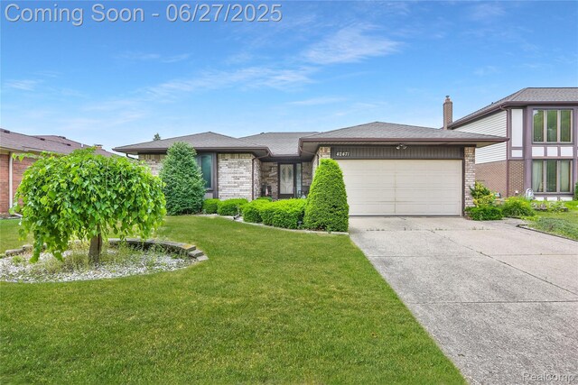 42471 Arcadia Dr, Sterling Heights, MI 48313 - view of front of home with an attached garage, concrete driveway, a front lawn, and brick siding