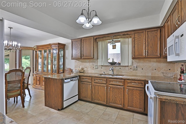 42471 Arcadia Dr, Sterling Heights, MI 48313 - kitchen with a chandelier, white appliances, a peninsula, and tasteful backsplash