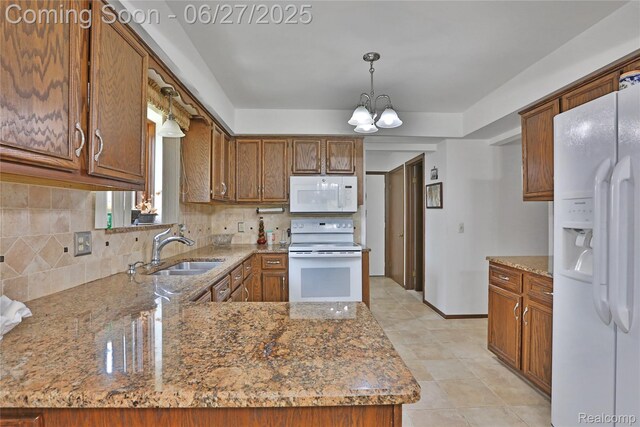 42471 Arcadia Dr, Sterling Heights, MI 48313 - kitchen featuring white appliances, tasteful backsplash, a chandelier, and brown cabinetry