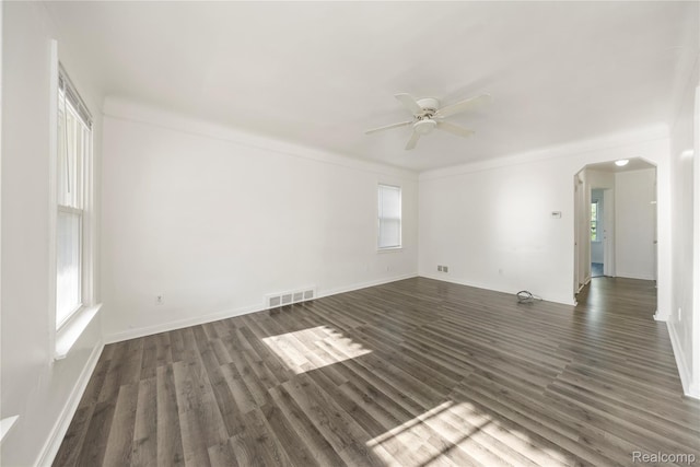 20258 Caldwell St, Detroit, MI 48234 - spare room featuring arched walkways, a ceiling fan, and dark wood-style floors
