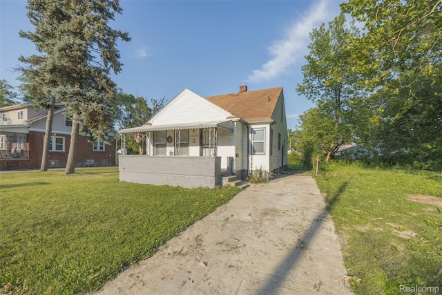 20258 Caldwell St, Detroit, MI 48234 - bungalow with a front yard, concrete driveway, and a chimney