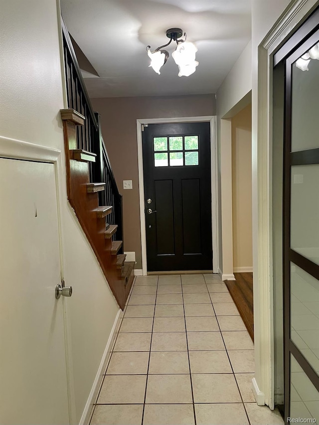 21150 E Chigwidden St, Northville, MI 48167 - entryway with light tile patterned floors, a chandelier, and stairway