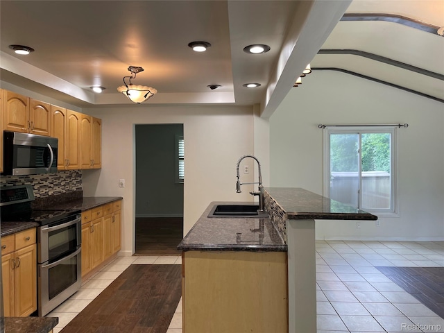 21150 E Chigwidden St, Northville, MI 48167 - kitchen featuring stainless steel appliances, backsplash, light tile patterned floors, light brown cabinetry, and lofted ceiling