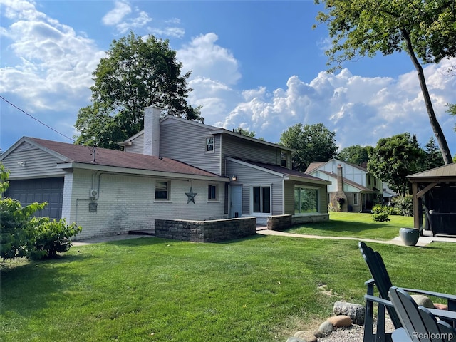 21150 E Chigwidden St, Northville, MI 48167 - back of property with a garage, a lawn, a chimney, brick siding, and roof with shingles