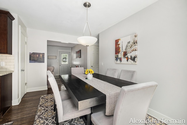 1602 4th St NW, Grand Rapids, MI 49504 - dining area featuring baseboards and dark wood-style floors