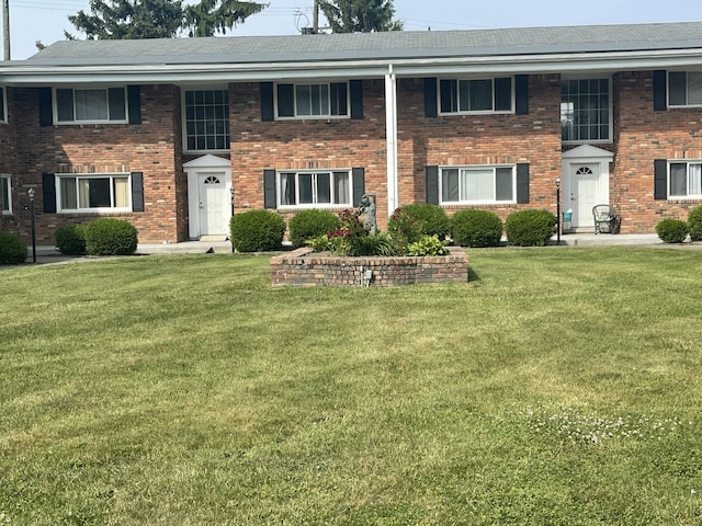 31831 Grand River Ave Unit 96, Farmington, MI 48336 - view of front facade with a front lawn and brick siding