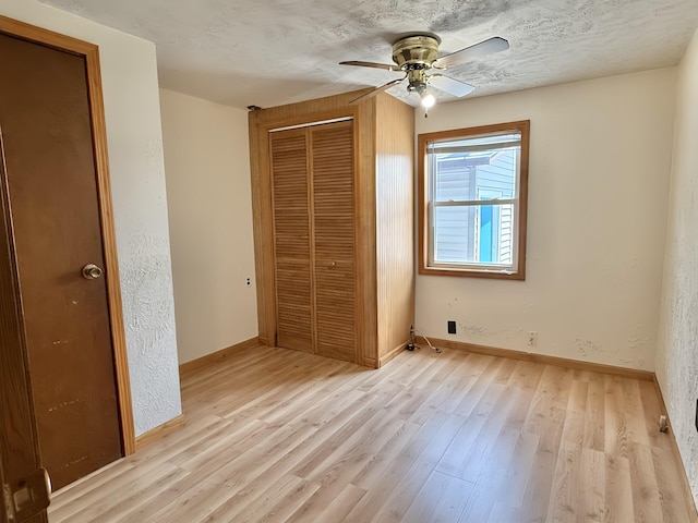 801 S 1st St, Buckley, MI 49620 - unfurnished bedroom featuring a closet, light wood-style flooring, and a ceiling fan