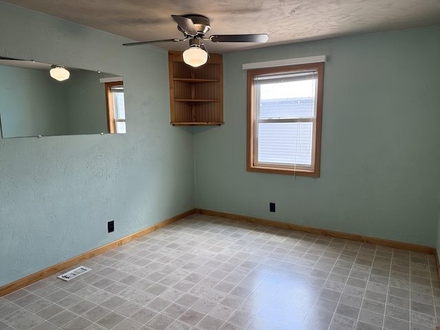 801 S 1st St, Buckley, MI 49620 - unfurnished room with plenty of natural light, ceiling fan, and a textured wall