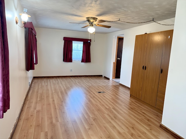 801 S 1st St, Buckley, MI 49620 - unfurnished bedroom featuring light wood-style flooring and ceiling fan