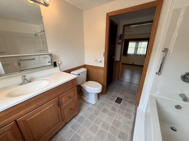 801 S 1st St, Buckley, MI 49620 - bathroom with a wainscoted wall, vanity, shower / washtub combination, and wooden walls