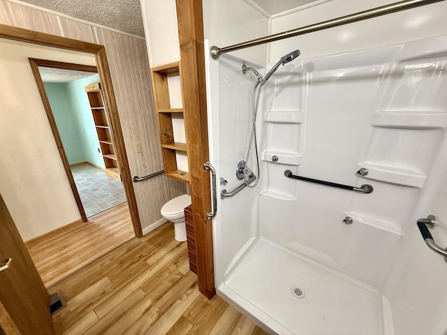 801 S 1st St, Buckley, MI 49620 - full bath with wood finished floors, a shower stall, and a textured ceiling
