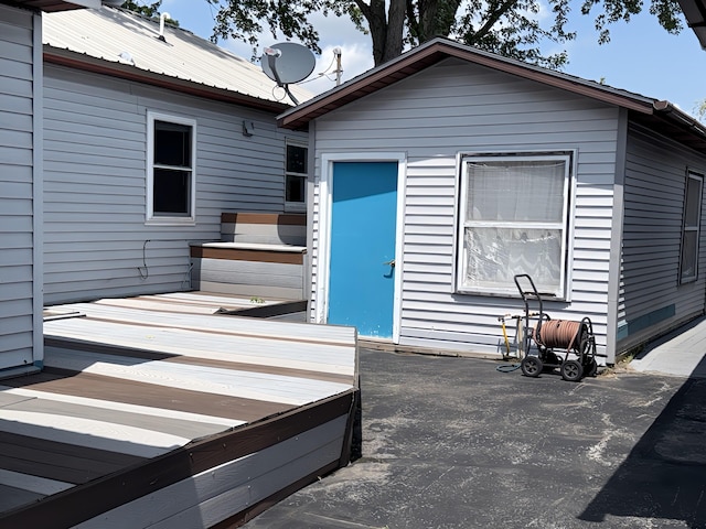 801 S 1st St, Buckley, MI 49620 - back of house featuring a deck and a metal roof