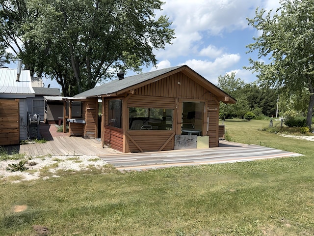 801 S 1st St, Buckley, MI 49620 - back of house with a lawn, a deck, and board and batten siding