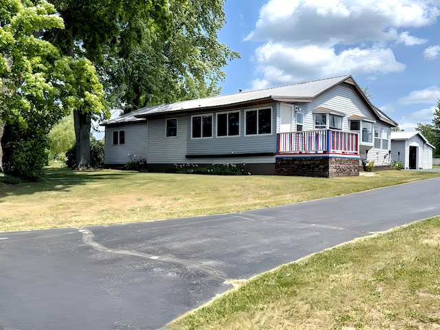 801 S 1st St, Buckley, MI 49620 - view of front facade with a metal roof and a front lawn
