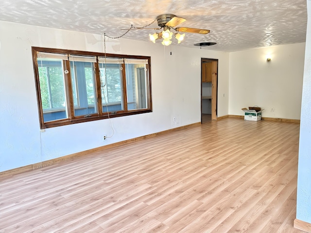801 S 1st St, Buckley, MI 49620 - empty room with wood finished floors and a ceiling fan