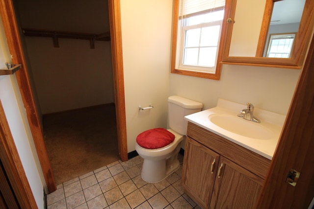 25652 Chernick St, Taylor, MI 48180 - bathroom featuring vanity, a spacious closet, and tile patterned floors