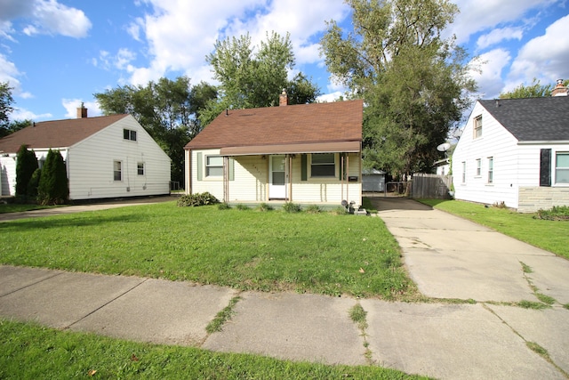 24352 Powers Ave, Dearborn Heights, MI 48125 - bungalow-style house with driveway, a chimney, and covered porch