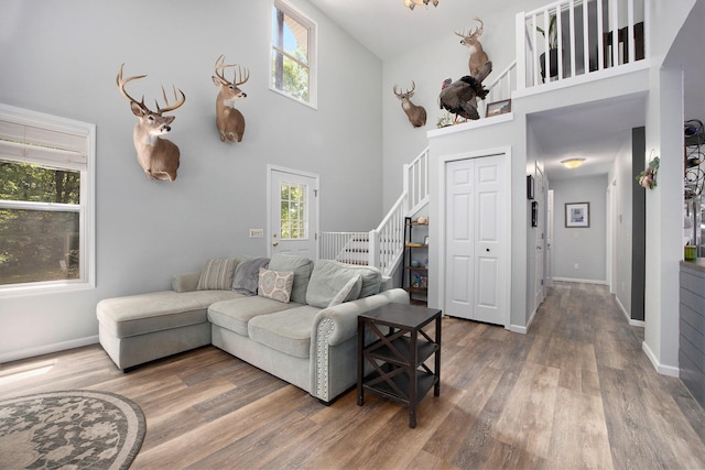 21008 Tamarack Rd, Howard City, MI 49329 - living area with a high ceiling, wood finished floors, and stairway
