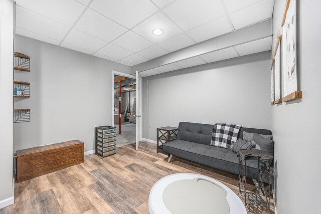21008 Tamarack Rd, Howard City, MI 49329 - living room featuring wood finished floors and a paneled ceiling