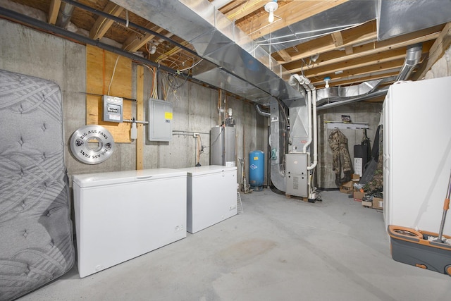 21008 Tamarack Rd, Howard City, MI 49329 - unfinished below grade area featuring a water pressure tank, heating unit, refrigerator, electric panel, and water heater