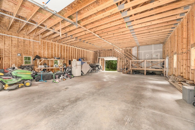21008 Tamarack Rd, Howard City, MI 49329 - garage featuring freestanding refrigerator