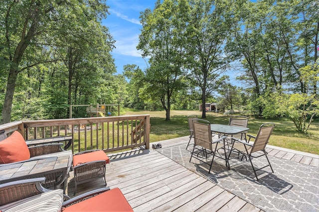21008 Tamarack Rd, Howard City, MI 49329 - wooden terrace with outdoor dining space, a lawn, and a playground