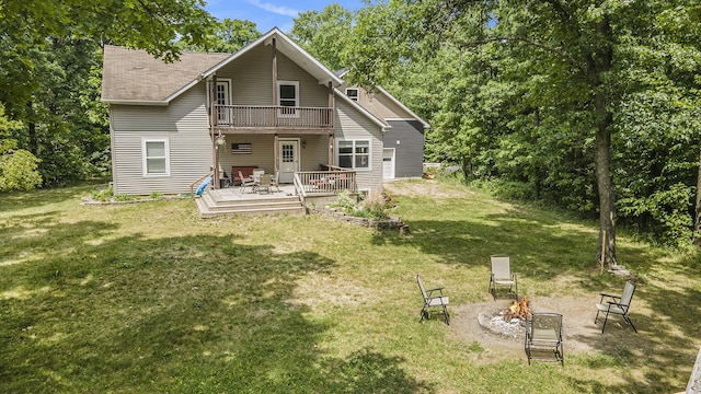 21008 Tamarack Rd, Howard City, MI 49329 - back of property featuring a fire pit, a balcony, a deck, and a lawn