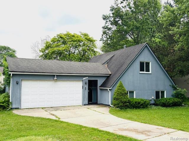 11638 Alois St, Livonia, MI 48150 - view of front facade with a front lawn, an attached garage, driveway, and a shingled roof