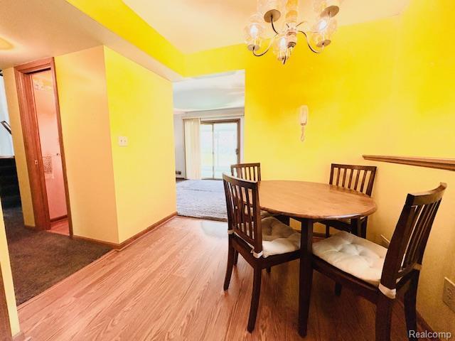 11638 Alois St, Livonia, MI 48150 - dining room featuring a chandelier and light wood-style floors