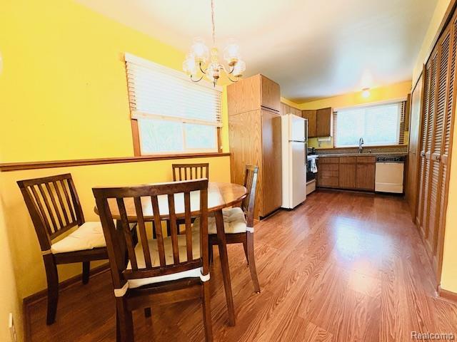 11638 Alois St, Livonia, MI 48150 - dining space featuring a chandelier and dark wood-style floors