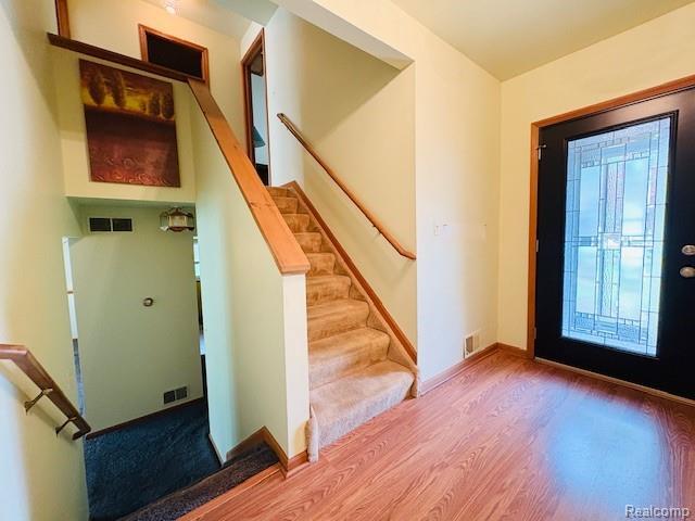 11638 Alois St, Livonia, MI 48150 - foyer entrance featuring wood finished floors and stairs
