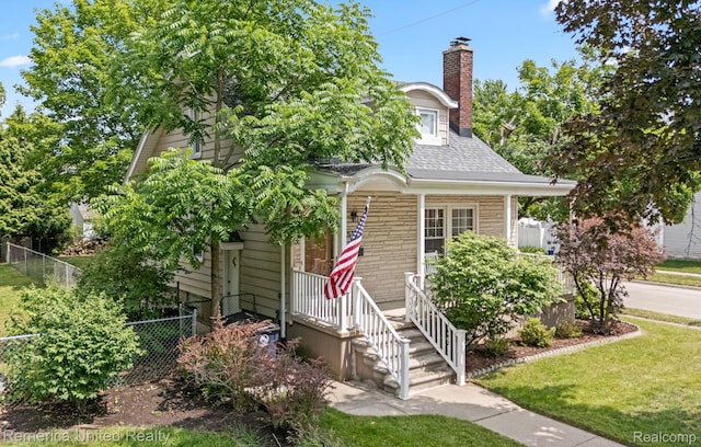 535 S Edison Ave, Royal Oak, MI 48067 - obstructed view of property featuring a porch, a chimney, and a shingled roof