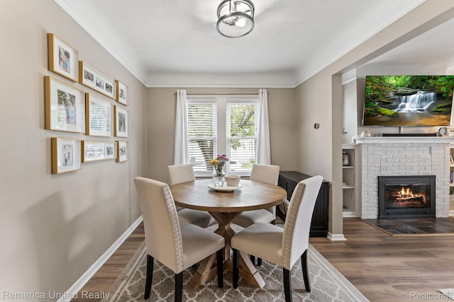535 S Edison Ave, Royal Oak, MI 48067 - dining room featuring wood finished floors, a brick fireplace, and ornamental molding