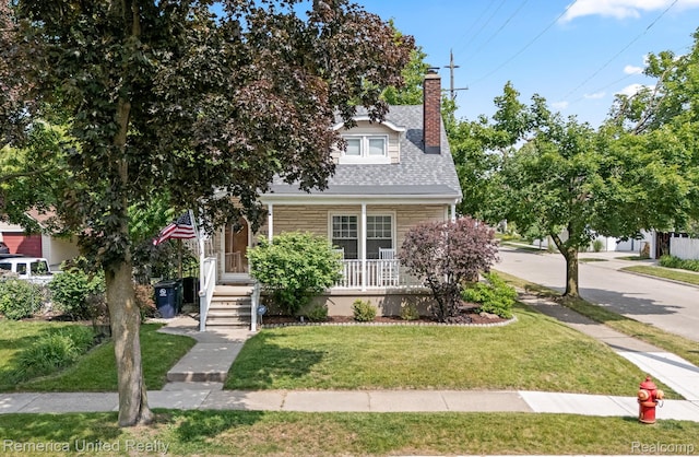 535 S Edison Ave, Royal Oak, MI 48067 - view of property hidden behind natural elements with a porch, a front lawn, a chimney, and a shingled roof