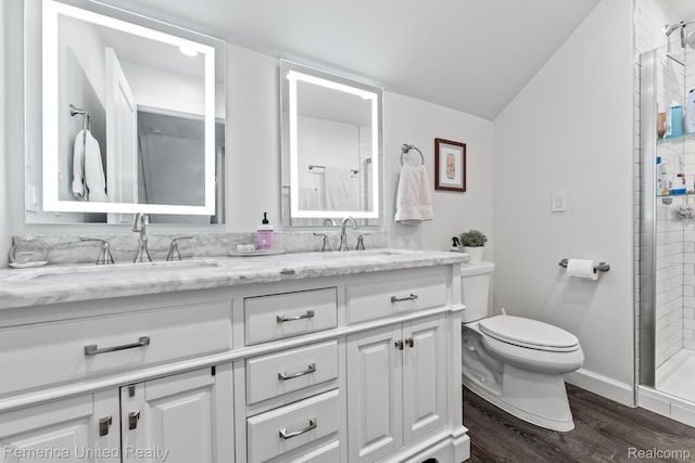 535 S Edison Ave, Royal Oak, MI 48067 - full bathroom with double vanity, wood finished floors, vaulted ceiling, and tiled shower