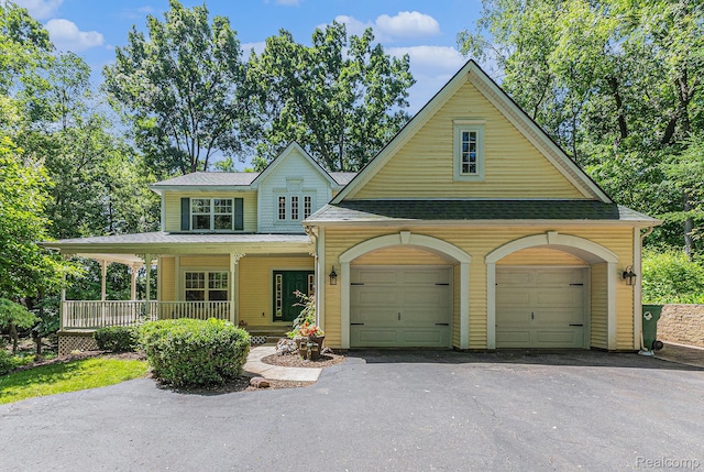 6155 Carey Rd, Commerce Twp, MI 48382 - view of front of house with driveway, a porch, and a garage