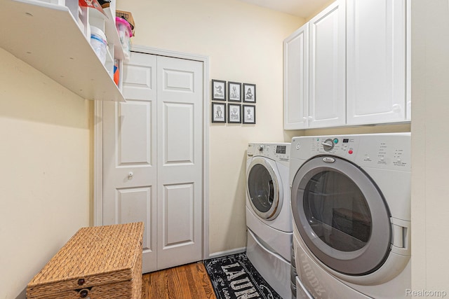6155 Carey Rd, Commerce Twp, MI 48382 - laundry area with independent washer and dryer, wood finished floors, and cabinet space