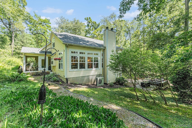 6155 Carey Rd, Commerce Twp, MI 48382 - back of property featuring a chimney and a shingled roof