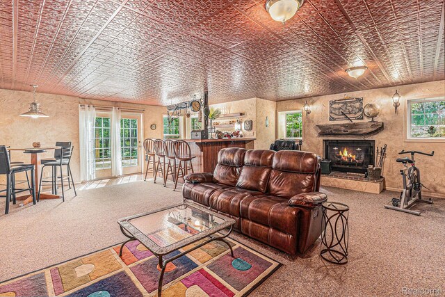 6155 Carey Rd, Commerce Twp, MI 48382 - living room featuring an ornate ceiling, carpet flooring, plenty of natural light, and a warm lit fireplace