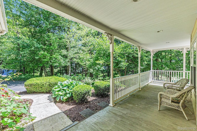 6155 Carey Rd, Commerce Twp, MI 48382 - porch featuring view of wooded area
