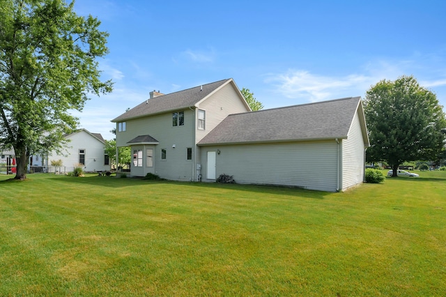 64670 Windrose Way, Lawton, MI 49065 - back of house featuring a yard, roof with shingles, and a chimney