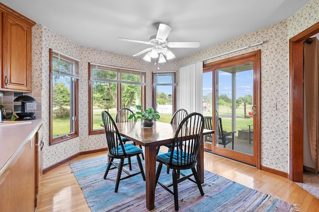 64670 Windrose Way, Lawton, MI 49065 - dining space with wallpapered walls, light wood-style floors, and ceiling fan
