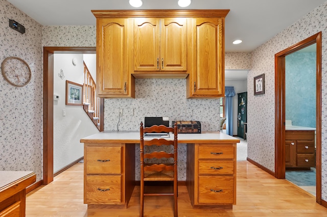 64670 Windrose Way, Lawton, MI 49065 - kitchen featuring light wood-type flooring, wallpapered walls, light countertops, and an office area