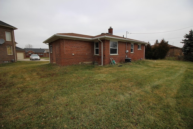 3816 Pokley Ct, Sterling Heights, MI 48310 - rear view of house featuring a chimney, brick siding, and a yard