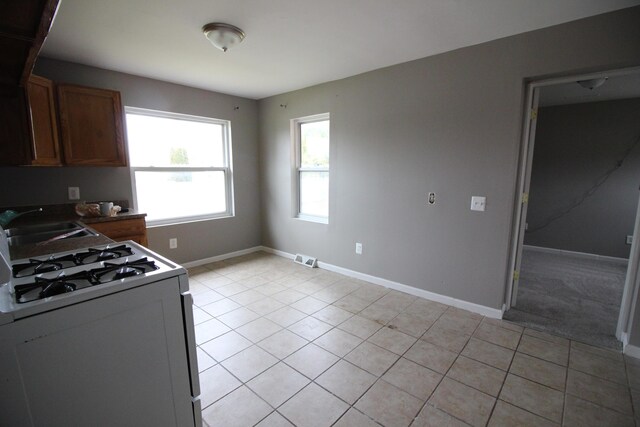 3816 Pokley Ct, Sterling Heights, MI 48310 - kitchen featuring gas range and light tile patterned floors