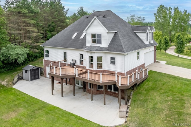 12462 Lillie Rd, Byron, MI 48418 - rear view of property featuring brick siding, a deck, a patio area, a yard, and a shed