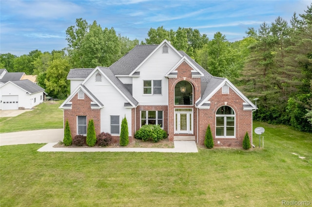 12462 Lillie Rd, Byron, MI 48418 - traditional-style home with brick siding and a front yard