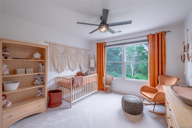 12462 Lillie Rd, Byron, MI 48418 - carpeted bedroom with a nursery area and a ceiling fan