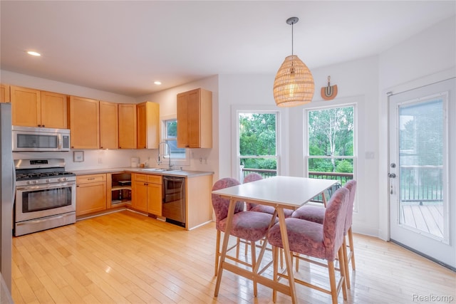 12462 Lillie Rd, Byron, MI 48418 - kitchen featuring stainless steel appliances, light brown cabinets, light wood-style floors, light countertops, and recessed lighting